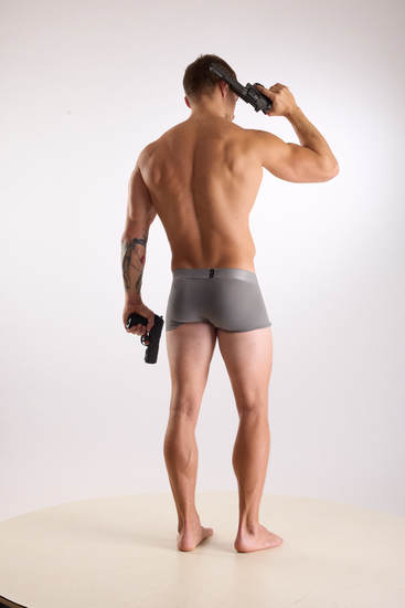 Man Adult Muscular White Fighting with gun Standing poses Underwear