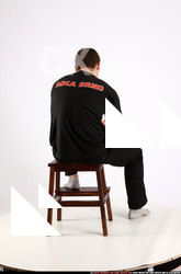 Man Adult Average White Fighting with gun Sitting poses Casual