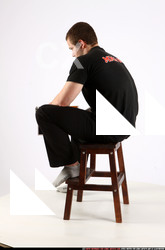 Man Adult Average White Fighting with gun Sitting poses Casual