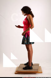 ELLIE-STANDING-USING-CELLPHONE