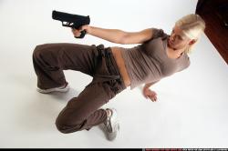 Woman Young Athletic White Fighting with gun Kneeling poses Sportswear