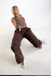 Woman Young Athletic White Fighting with gun Kneeling poses Sportswear