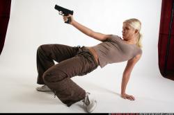 Woman Young Athletic White Fighting with gun Kneeling poses Sportswear