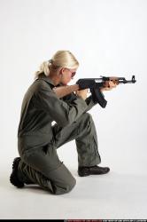 Woman Adult Athletic White Fighting with submachine gun Kneeling poses Army