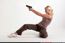 Woman Adult Athletic White Fighting with gun Kneeling poses Sportswear