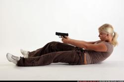 Woman Adult Athletic White Fighting with gun Laying poses Sportswear