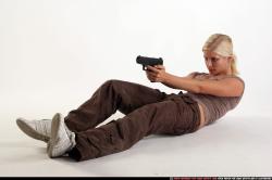 Woman Adult Athletic White Fighting with gun Laying poses Sportswear