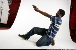 Man Young Athletic Black Fighting with gun Kneeling poses Sportswear