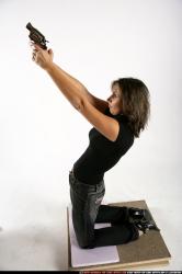 Woman Adult Average White Fighting with gun Kneeling poses Casual