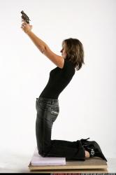 Woman Adult Average White Fighting with gun Kneeling poses Casual