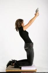 Woman Adult Average White Fighting with gun Kneeling poses Casual