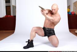 Man Adult Muscular White Fighting with gun Kneeling poses Underwear