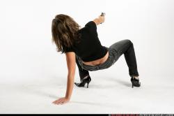 Woman Adult Athletic White Fighting with gun Crouching Casual