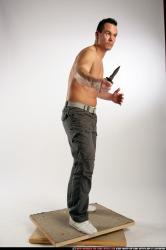 Man Adult Athletic White Fighting with knife Standing poses Pants