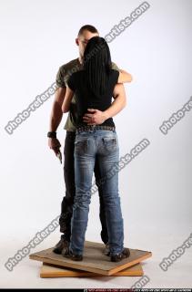 couple-hugging-guns