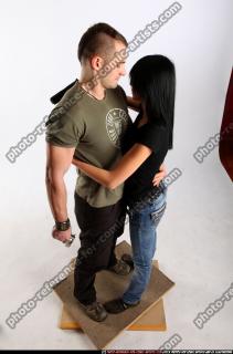 couple-hugging-guns