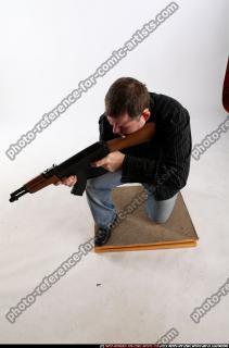 daniel-kneeling-aiming-ak