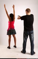 Man & Woman Young Athletic Black & White Fighting with gun Standing poses Sportswear