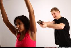 Man & Woman Young Athletic Black & White Fighting with gun Standing poses Sportswear