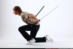 Man Young Athletic Another Fighting with sword Kneeling poses Sportswear