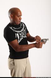 Man Old Average Black Fighting with gun Standing poses Casual