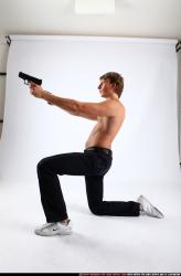 Man Young Athletic White Fighting with gun Kneeling poses Pants