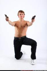 Man Young Athletic White Fighting with gun Kneeling poses Pants