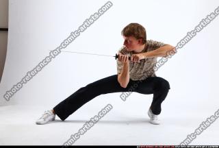 2010 10 PATRICK KNEELING KATANA DEFEND POSE 00