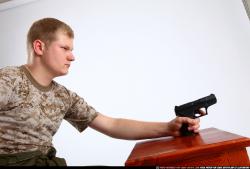 Man Adult Average White Fighting with gun Sitting poses Army