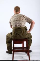 Man Adult Average White Fighting with gun Sitting poses Army