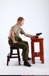 Man Adult Average White Fighting with gun Sitting poses Army