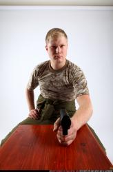 Man Adult Average White Fighting with gun Sitting poses Army