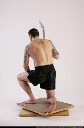 Man Adult Athletic White Fighting with spear Kneeling poses Sportswear