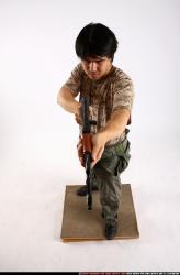 Man Adult Average Fighting with submachine gun Standing poses Army Asian