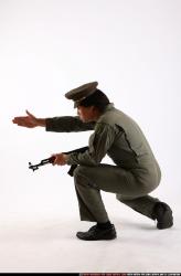 Man Adult Average Fighting with submachine gun Kneeling poses Army Asian