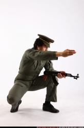 Man Adult Average Fighting with submachine gun Kneeling poses Army Asian