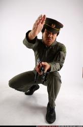 Man Adult Average Fighting with submachine gun Kneeling poses Army Asian