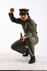 Man Adult Average Fighting with submachine gun Kneeling poses Army Asian