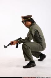 Man Adult Average Fighting with submachine gun Kneeling poses Army Asian