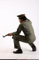 Man Adult Average Fighting with submachine gun Kneeling poses Army Asian