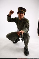 Man Adult Average Fighting with submachine gun Kneeling poses Army Asian