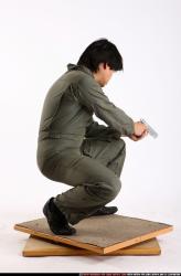 Man Adult Average Fighting with gun Kneeling poses Army Asian