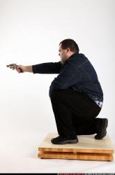 Santo-kneeling-revolver-shooting