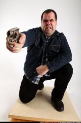 Santo-kneeling-revolver-shooting