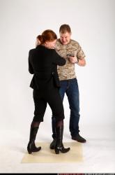 Man & Woman Adult Average White Fighting with gun Standing poses Casual