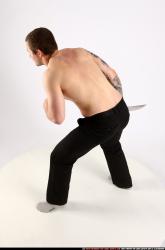 Man Adult Athletic White Fighting with knife Standing poses Pants