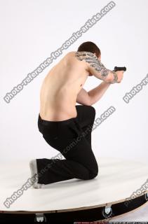 alex-kneeling-aiming-pistol