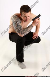 alex-kneeling-guarding-pistol