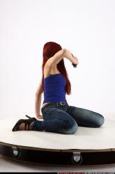 Woman Young Athletic White Fighting with gun Kneeling poses Casual