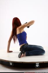 Woman Young Athletic White Fighting with gun Kneeling poses Casual